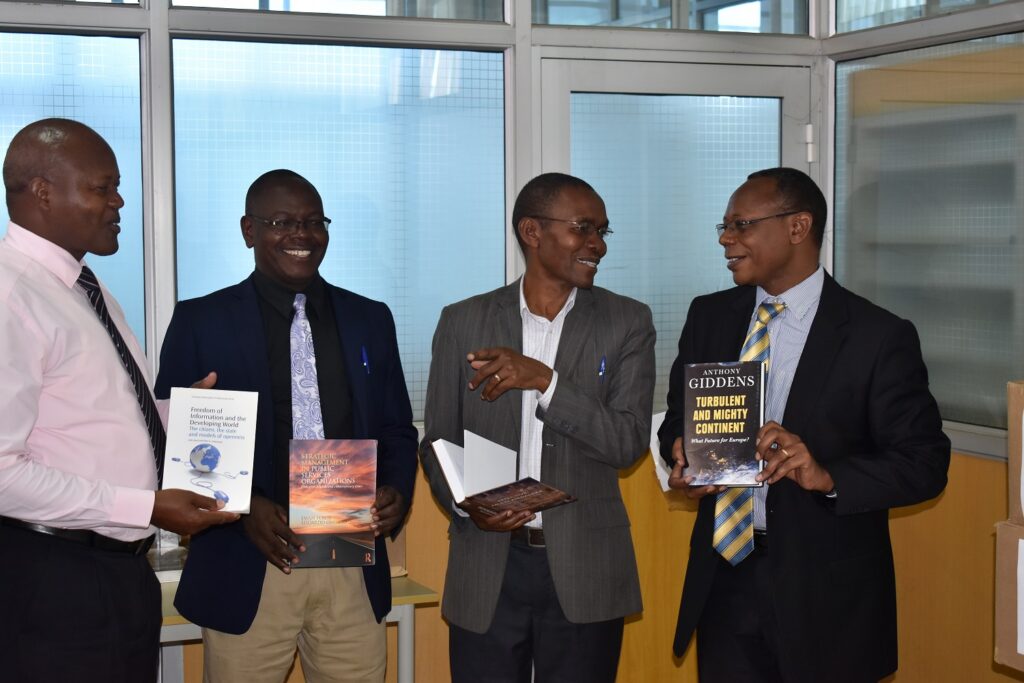 Dr. Clay Westcott donating books to the Kenyatta University Post Modern Library